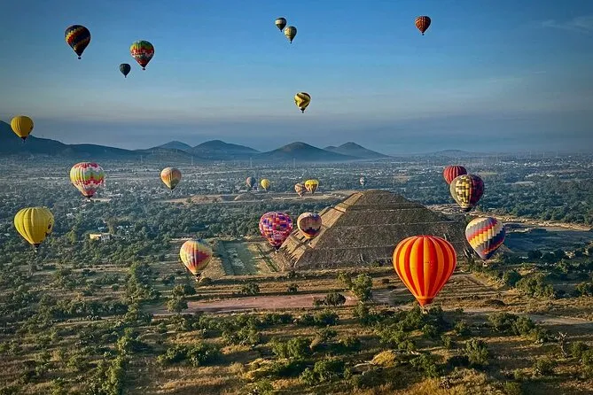 Small-group hot air balloon Mexico City tour floating over Teotihuacan ruins at sunrise